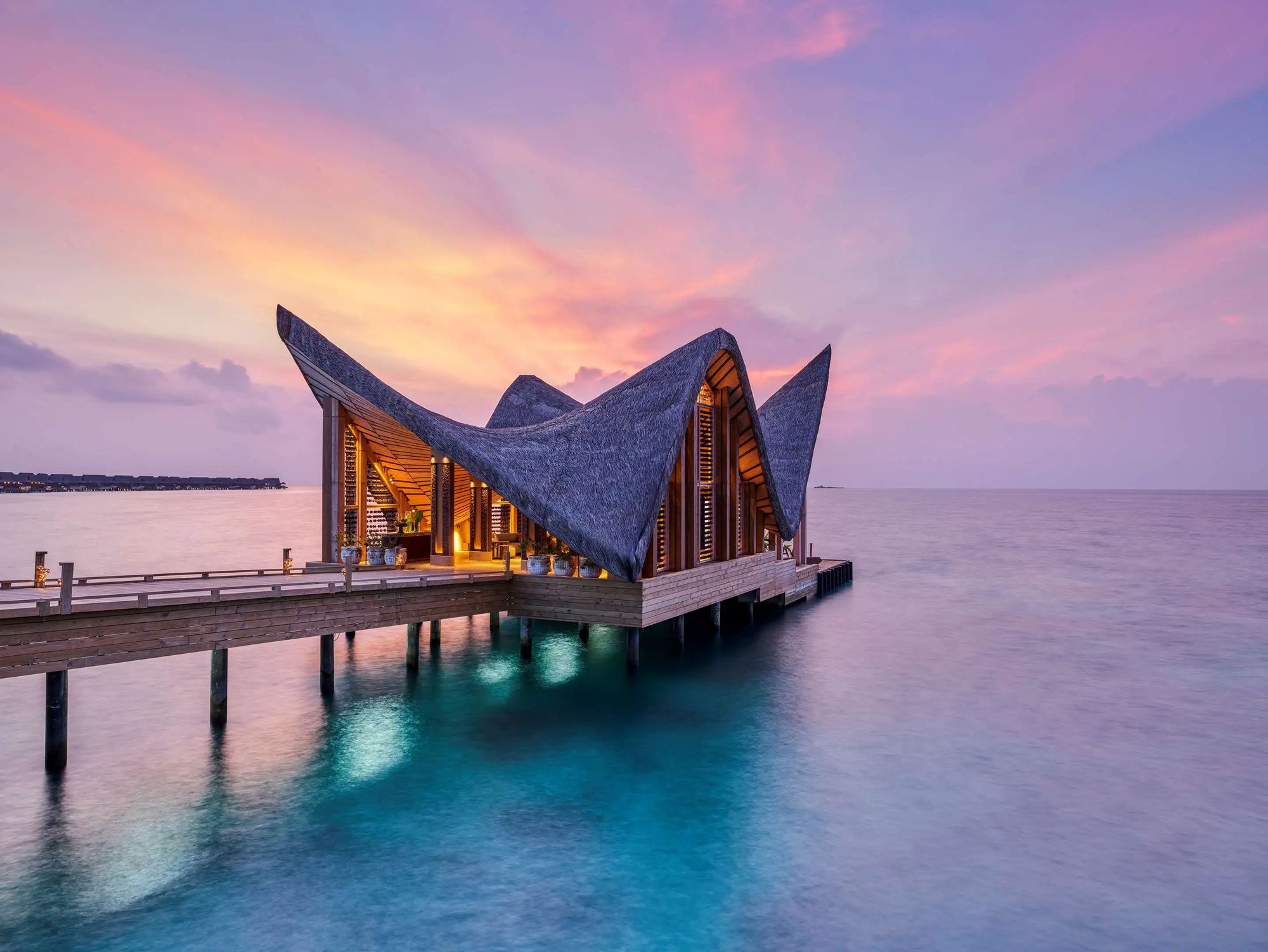 An overwater pavilion at dusk
